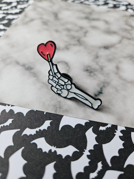 lollipop skeleton hand pin badge