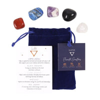 A set of five different colored gemstone tumblestones, including Lapis Lazuli, Black Obsidian, Clear Quartz, Amethyst, and Red Jasper, presented in a blue velvet drawstring bag with a hang tag and an informative insert card.