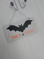 trick or treat bat hanging wall sign